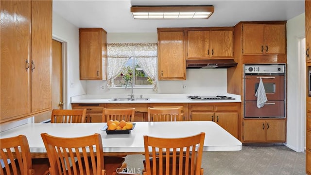 5427 Picker St, Riverside, CA 92503 - kitchen featuring a sink, a warming drawer, brown cabinetry, and under cabinet range hood