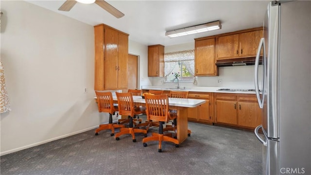 5427 Picker St, Riverside, CA 92503 - kitchen with freestanding refrigerator, under cabinet range hood, stovetop, light countertops, and ceiling fan