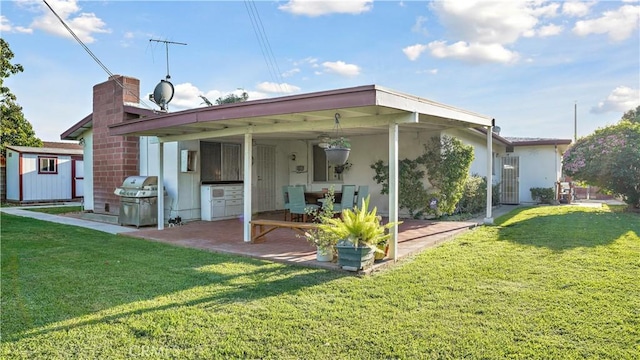 5427 Picker St, Riverside, CA 92503 - rear view of house featuring a patio, a yard, a storage unit, and an outdoor structure