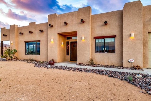 southwest-style home featuring stucco siding