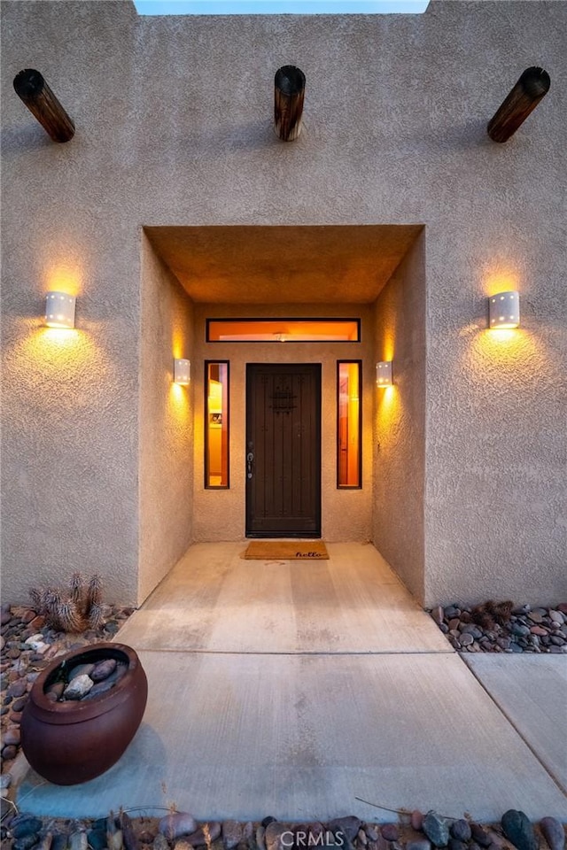 doorway to property with stucco siding