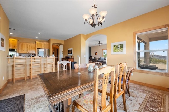 61465 Latham Trl, Joshua Tree, CA 92252 - dining area with arched walkways, a ceiling fan, baseboards, a chandelier, and recessed lighting