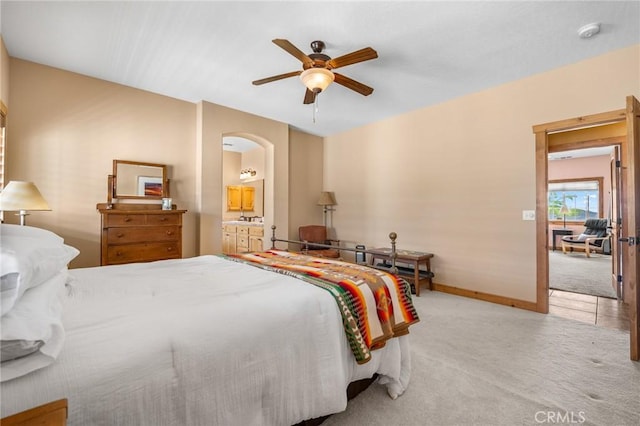 61465 Latham Trl, Joshua Tree, CA 92252 - bedroom featuring carpet floors, arched walkways, ceiling fan, baseboards, and ensuite bathroom