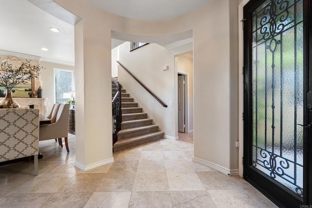 entrance foyer with baseboards, stairs, ornamental molding, and recessed lighting