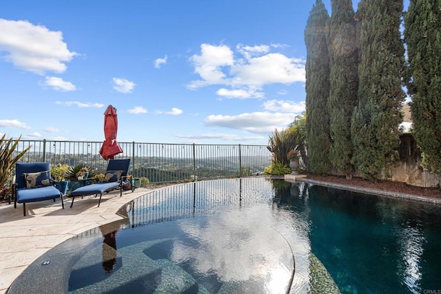 view of swimming pool with a patio, a fenced in pool, and a fenced backyard