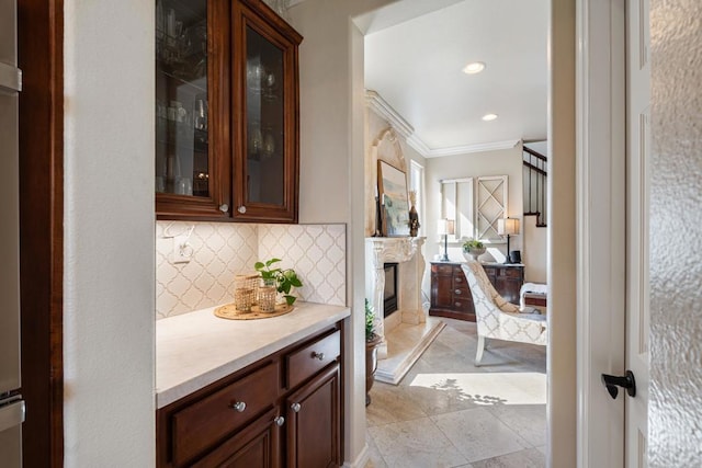 bar with recessed lighting, a high end fireplace, crown molding, and decorative backsplash