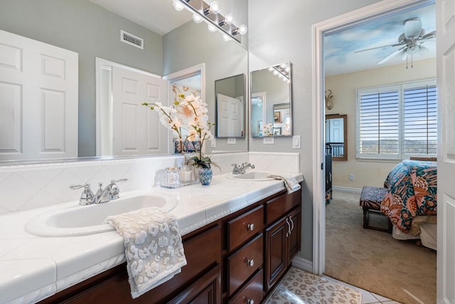 full bath featuring a sink, ceiling fan, tasteful backsplash, and ensuite bath