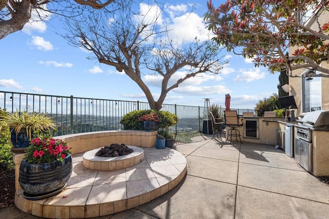 view of patio / terrace featuring grilling area, fence, area for grilling, and a fire pit