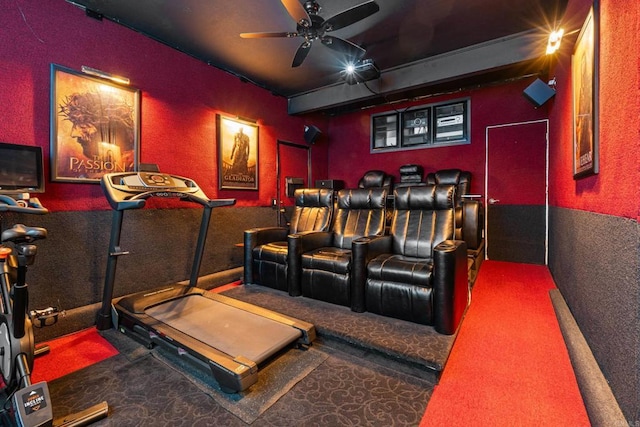 carpeted home theater with a ceiling fan