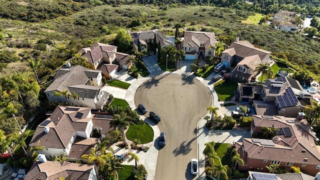 aerial view featuring a wooded view and a residential view