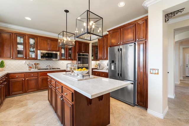 kitchen with stainless steel appliances, tasteful backsplash, light countertops, a center island, and a notable chandelier