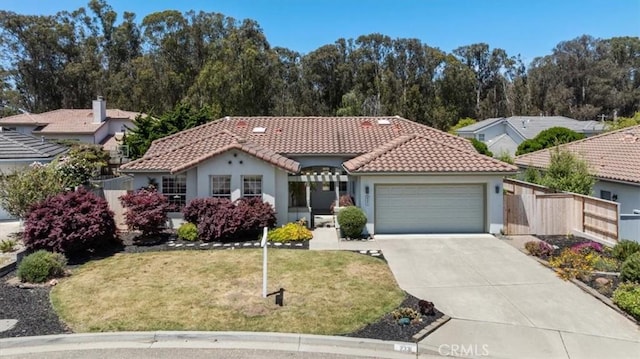 2331 Humboldt St, Los Osos, CA 93402 - mediterranean / spanish-style house featuring a garage, concrete driveway, a tile roof, and stucco siding