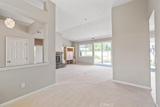 2331 Humboldt St, Los Osos, CA 93402 - unfurnished living room featuring carpet floors, baseboards, lofted ceiling, and a fireplace