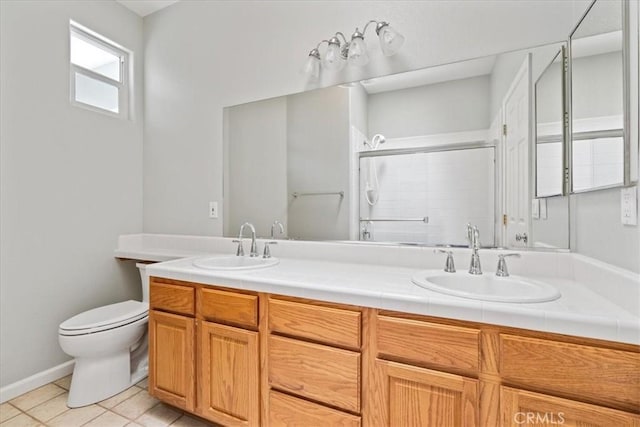 2331 Humboldt St, Los Osos, CA 93402 - bathroom featuring double vanity, toilet, a shower with shower door, tile patterned floors, and baseboards