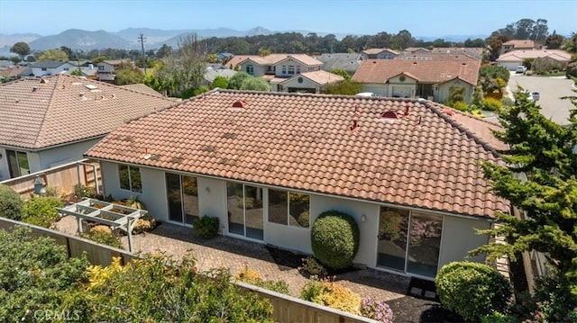 2331 Humboldt St, Los Osos, CA 93402 - back of house featuring a tiled roof, a residential view, a mountain view, and stucco siding