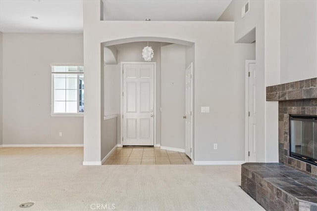 2331 Humboldt St, Los Osos, CA 93402 - foyer featuring carpet floors, a glass covered fireplace, arched walkways, and baseboards