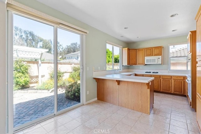 2331 Humboldt St, Los Osos, CA 93402 - kitchen featuring white appliances, a peninsula, light countertops, plenty of natural light, and recessed lighting