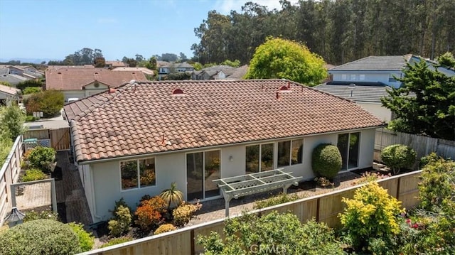2331 Humboldt St, Los Osos, CA 93402 - rear view of property featuring a tiled roof, a fenced backyard, and stucco siding