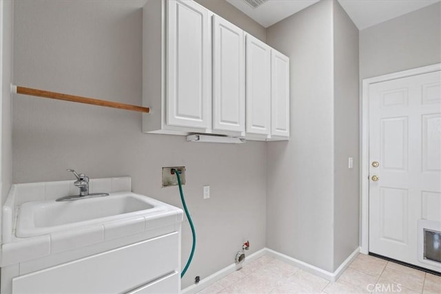 2331 Humboldt St, Los Osos, CA 93402 - laundry area with gas dryer hookup, washer hookup, baseboards, cabinet space, and light tile patterned flooring