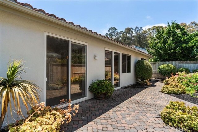 2331 Humboldt St, Los Osos, CA 93402 - property entrance with stucco siding, a patio, and a tiled roof