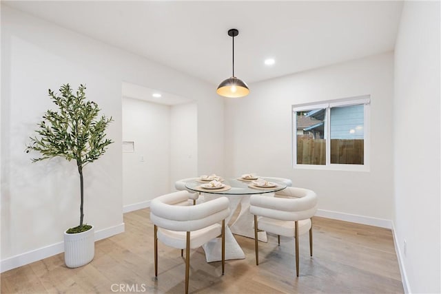 dining room featuring baseboards, light wood-type flooring, and recessed lighting