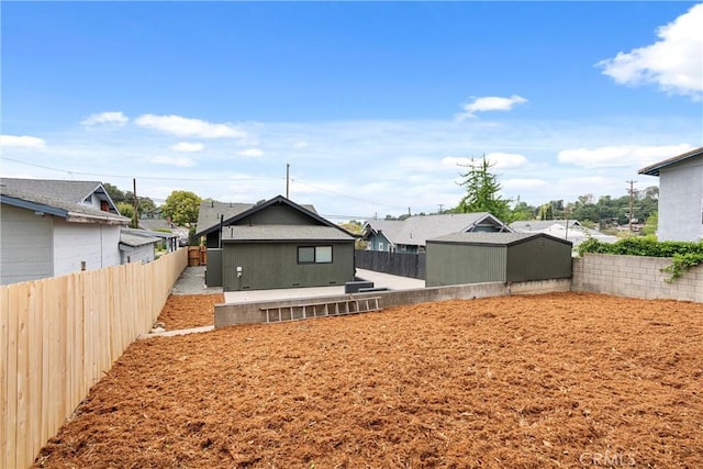back of house with a residential view and a fenced backyard