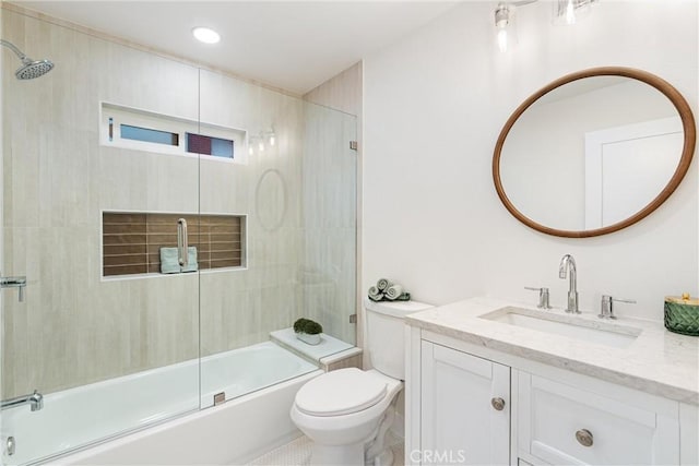 bathroom with toilet, recessed lighting, vanity, and combined bath / shower with glass door