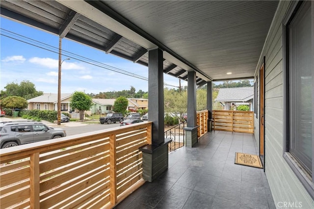 view of patio featuring a porch and a residential view