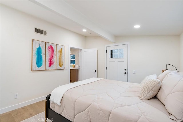 bedroom with beam ceiling, visible vents, baseboards, light wood-style floors, and recessed lighting