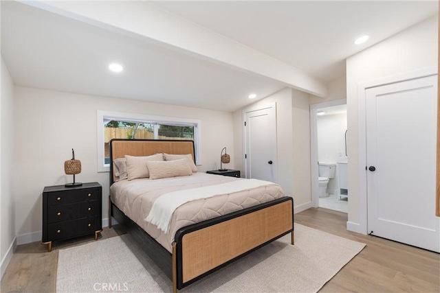 bedroom featuring light wood-style flooring, connected bathroom, baseboards, and recessed lighting