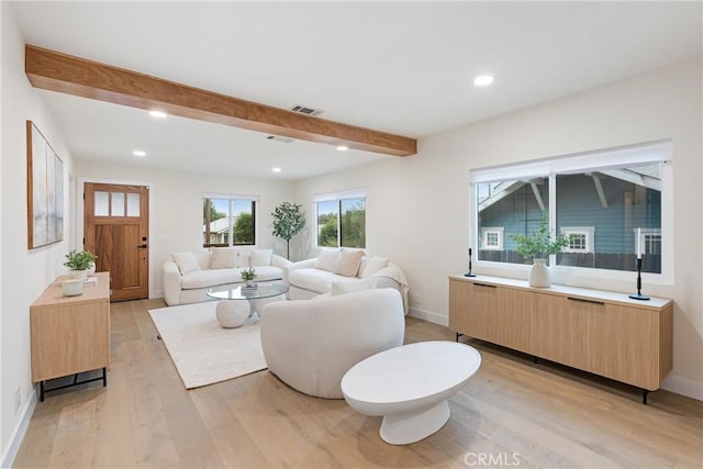 living area with light wood finished floors, visible vents, beamed ceiling, and recessed lighting