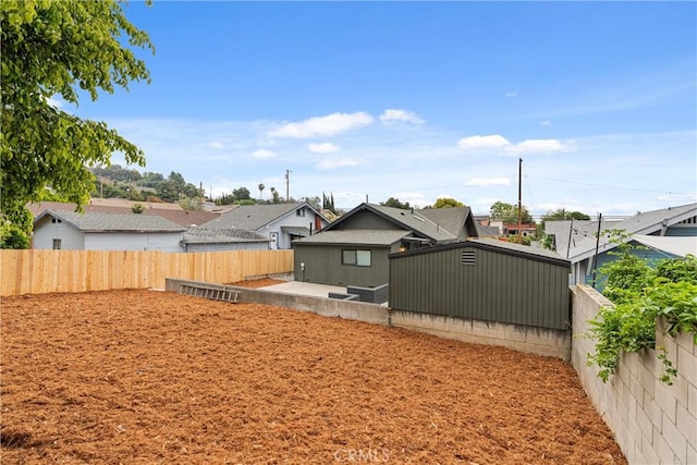 view of yard featuring a residential view and a fenced backyard