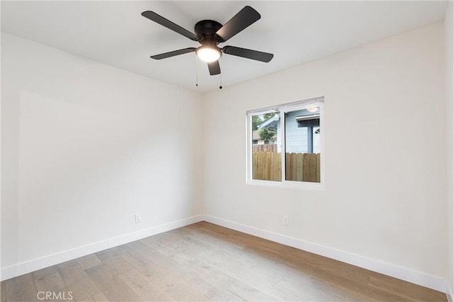 unfurnished room with ceiling fan, baseboards, and light wood-style floors