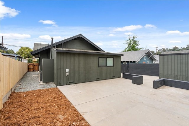 back of house with a fenced backyard, a patio area, and crawl space