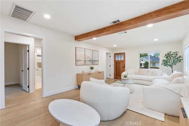 living area with light wood finished floors, recessed lighting, visible vents, and beam ceiling