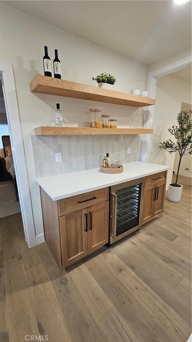 6123 Tipton Way, Los Angeles, CA 90042 - indoor dry bar featuring beverage cooler, light wood-style floors, and decorative backsplash