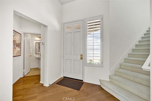 2516 Lewis Dr, Tustin, CA 92782 - foyer with stairs, light wood-style flooring, and baseboards