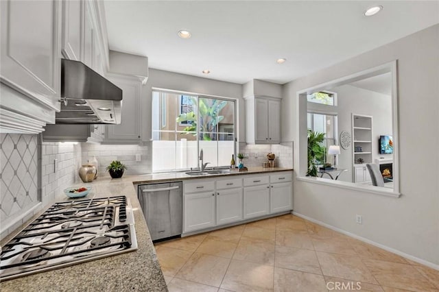 2516 Lewis Dr, Tustin, CA 92782 - kitchen with appliances with stainless steel finishes, range hood, a sink, tasteful backsplash, and recessed lighting