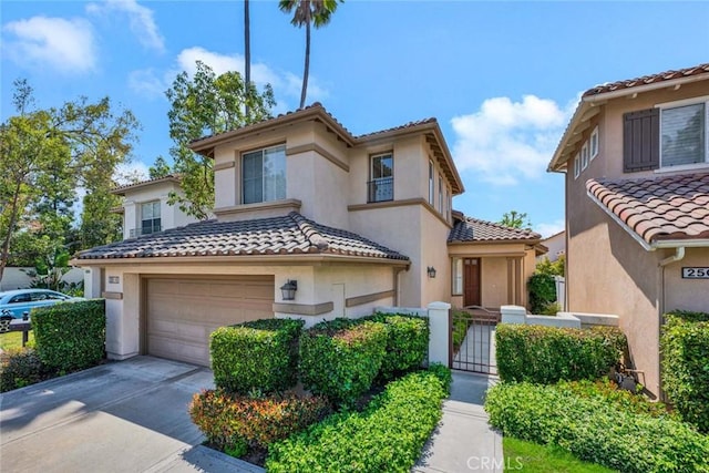 2516 Lewis Dr, Tustin, CA 92782 - mediterranean / spanish-style house featuring an attached garage, a tile roof, stucco siding, driveway, and a gate