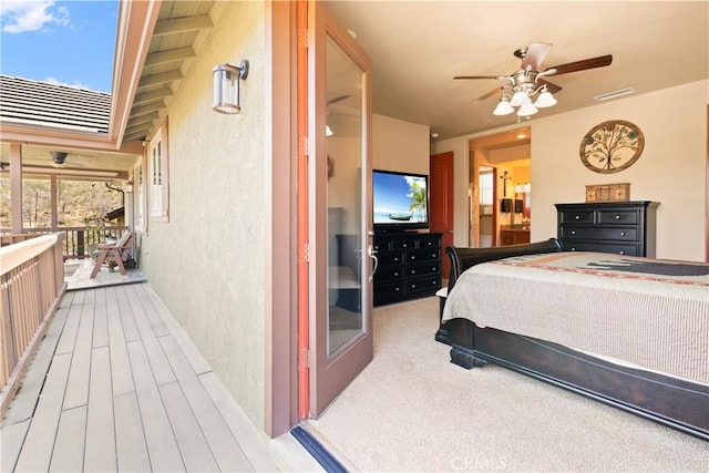 bedroom featuring visible vents, ceiling fan, and a textured wall