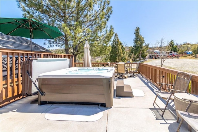 view of patio / terrace with a hot tub and outdoor dining area