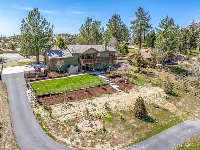 view of front of home featuring a fenced backyard, a deck, stairs, and stucco siding