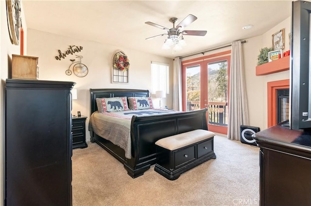 bedroom featuring ceiling fan, light carpet, and access to exterior