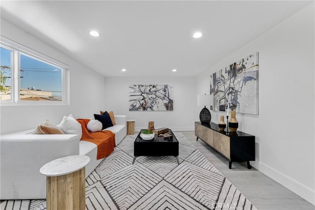 living room featuring baseboards and recessed lighting