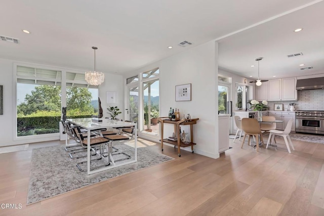 dining room with a chandelier, visible vents, and recessed lighting