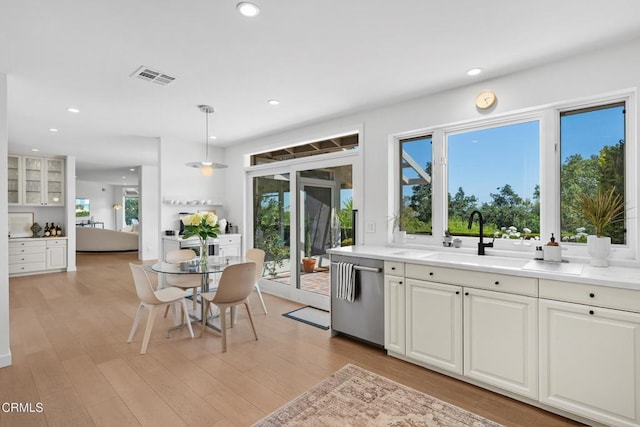 kitchen featuring recessed lighting, stainless steel dishwasher, visible vents, and a sink