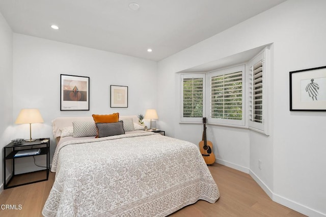 bedroom with light wood finished floors, baseboards, and recessed lighting