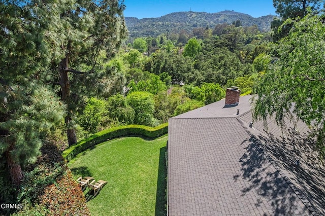 aerial view with a wooded view and a mountain view