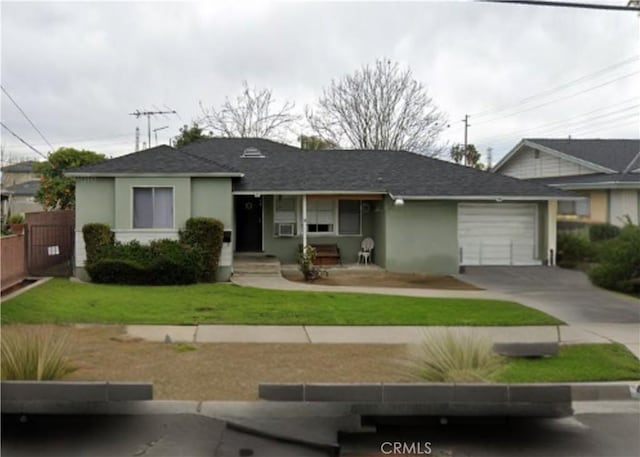 ranch-style house with a garage, stucco siding, concrete driveway, a front lawn, and roof with shingles