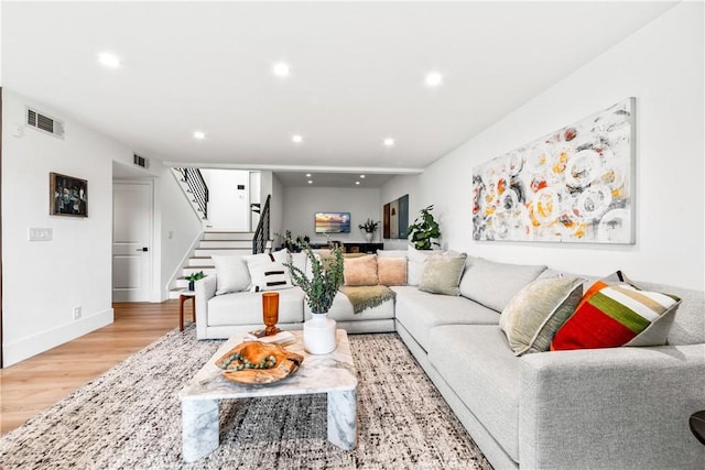 living area with visible vents, wood finished floors, stairway, and recessed lighting